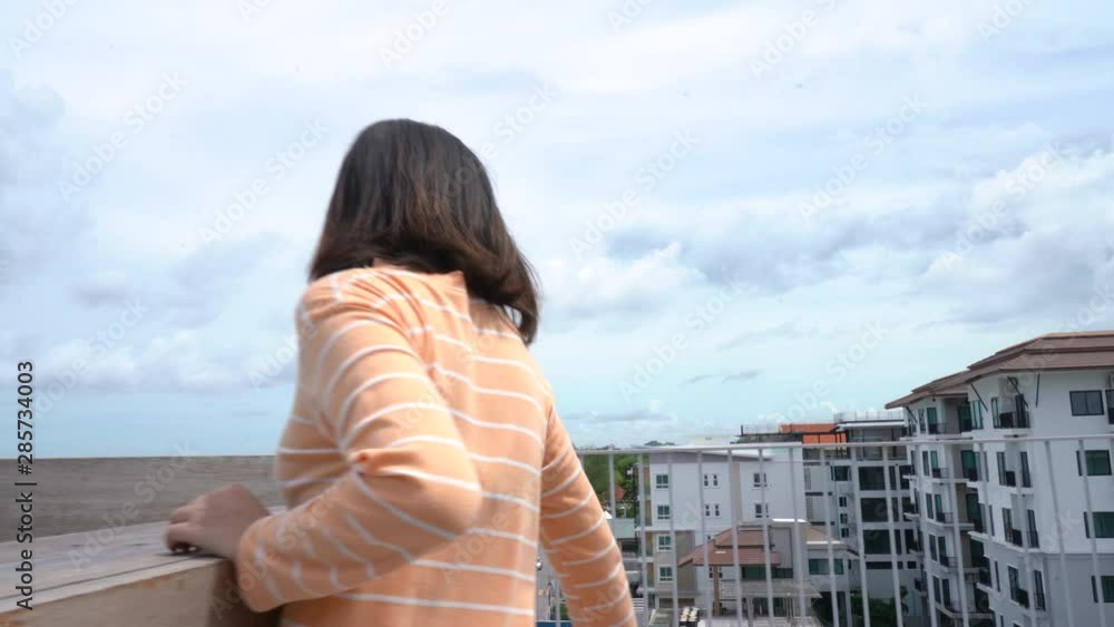 Beautiful yong asian woman walking on rooftop at hotel and sitting looking view travel people lifestyle Beautiful yong asian woman walking on rooftop at hotel and sitting looking view travel people lifestyle