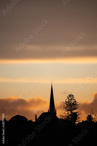 sunset behind a church © Bastien