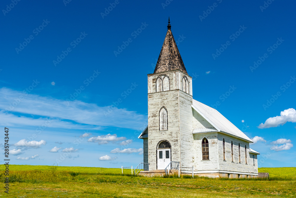 The historic Immanuel Lutheran Church in Admiral, Saskatchewan with a canola field in the background