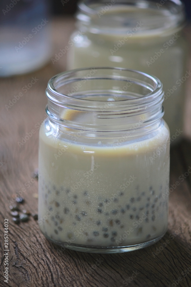 black sesame soy milk in glass on wood black sesame soy milk in glass on wood
