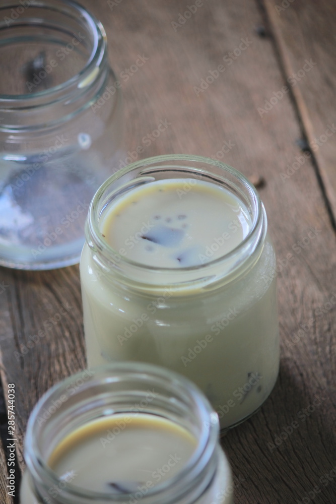 black sesame soy milk in glass on wood black sesame soy milk in glass on wood