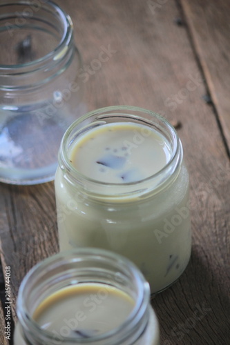 black sesame soy milk in glass on wood