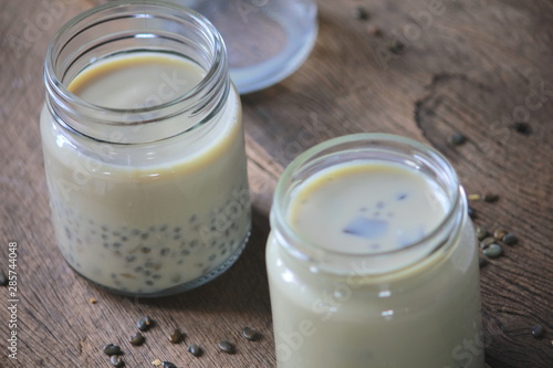 black sesame soy milk in glass on wood