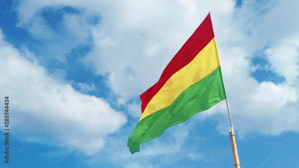 Red Yellow GreRasta Flag Blowing in the Wind on a Beautiful Blue Sky Day Red Yellow GreRasta Flag Blowing in the Wind on a Beautiful Blue Sky Day
