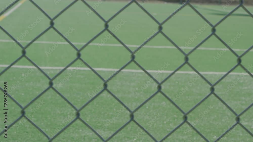 Close-up of a sports field from behind a fence Close-up of a sports field from behind a fence