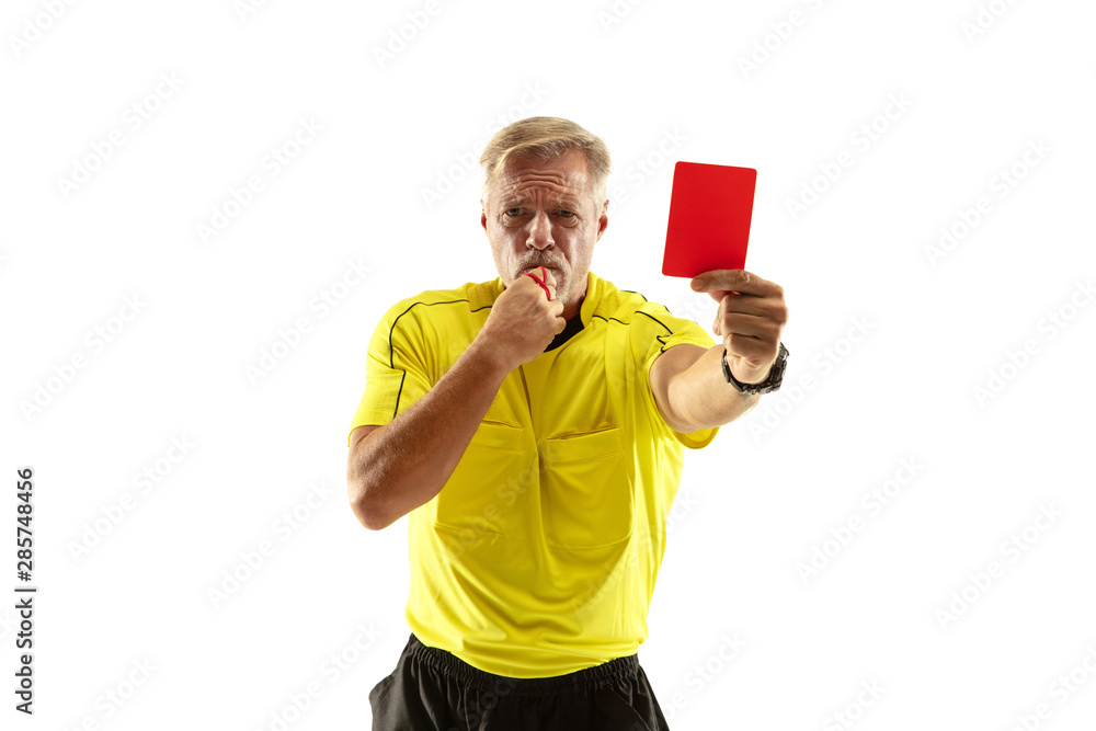 Referee showing a red card to a displeased football or soccer player