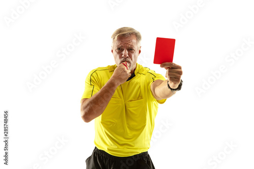 Referee showing a red card to a displeased football or soccer player while gaming isolated on white studio background. Concept of sport, rules violation, controversial issues, obstacles overcoming.