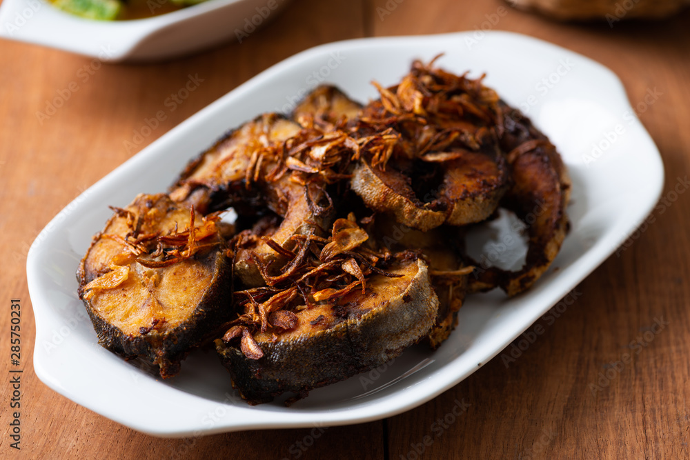 Deep Fried Fish Recipe in white plate on table Deep Fried Fish Recipe in white plate on table
