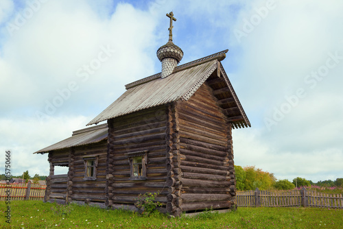 Wooden chapel of St. Nicholas the Wonderworker in the village of Gomorovichi close up on a cloudy August morning. Leningrad region, Russia