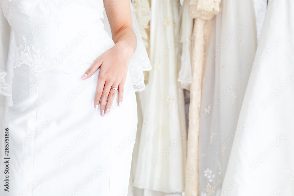 Portrait beautiful Asian woman with diamond ring in white luxury bridal dress Portrait beautiful Asian woman with diamond ring in white luxury bridal dress