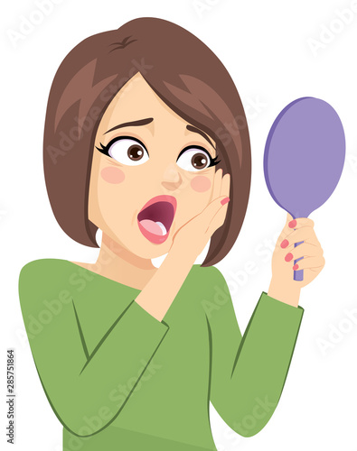 Middle Aged Woman sad about wrinkle around eyes looking on pocket mirror