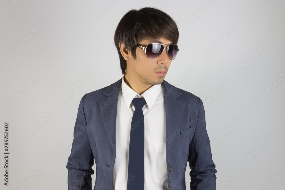 Young Asian Portrait Businessman in Navy Blue Suit Wear Sunglasses and Look Beside Young Asian Portrait Businessman in Navy Blue Suit Wear Sunglasses and Look Beside
