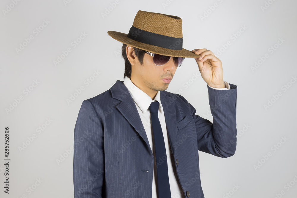 Young Asian Portrait Businessman in Navy Blue Suit Wear Sunglasses and Touch Hat Brim Young Asian Portrait Businessman in Navy Blue Suit Wear Sunglasses and Touch Hat Brim