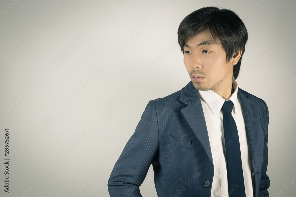 Young Asian Portrait Businessman Turn Back Pose at Right Frame in Vintage Tone Young Asian Portrait Businessman Turn Back Pose at Right Frame in Vintage Tone