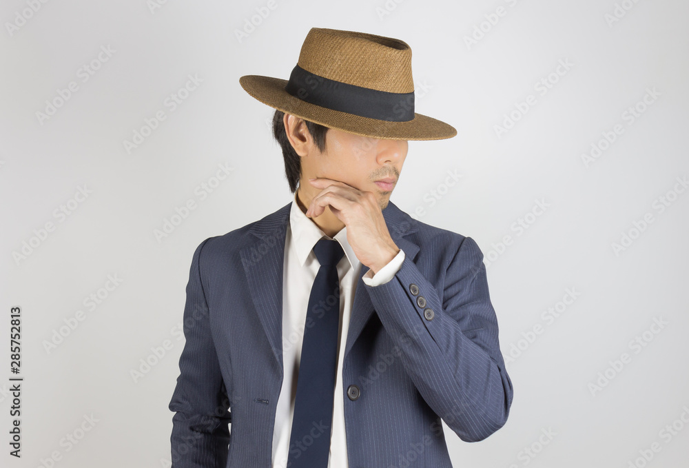 Young Asian Portrait Businessman in Navy Blue Suit Wear Hat and Touch Chin Pose Young Asian Portrait Businessman in Navy Blue Suit Wear Hat and Touch Chin Pose