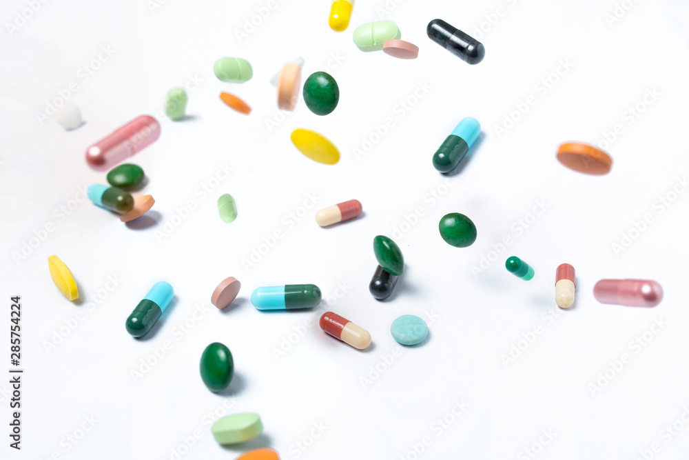 Colorful capsules and pills on white background. Concept of health Colorful capsules and pills on white background. Concept of health
