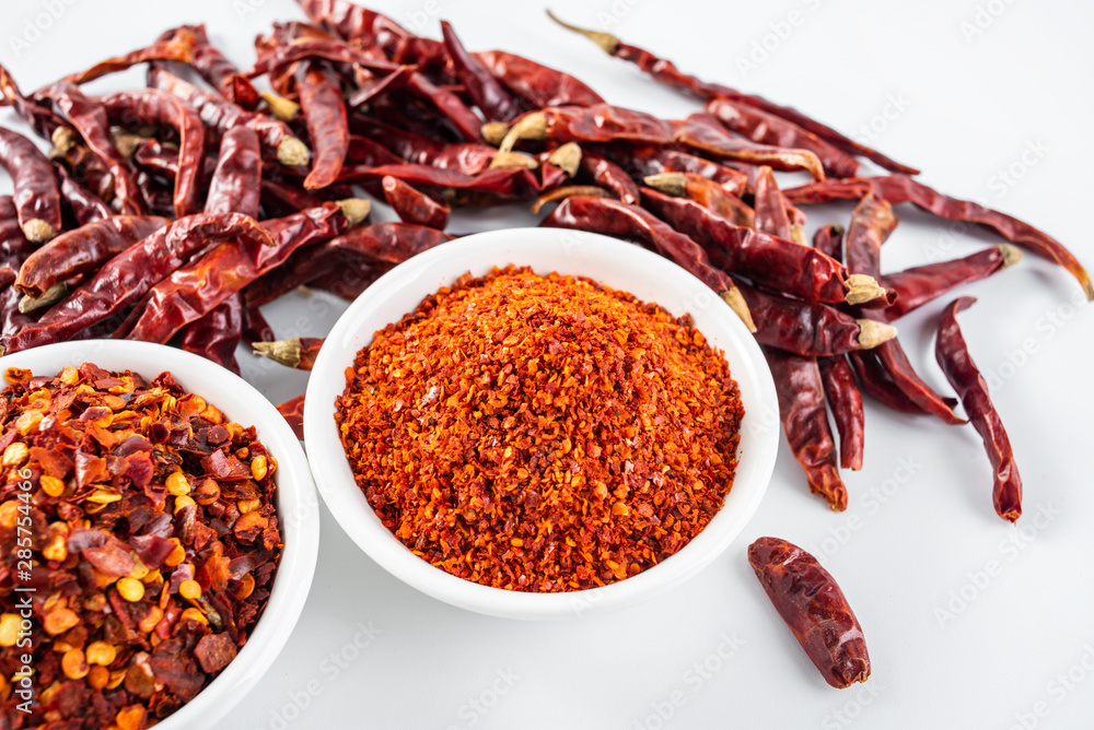 a plate of paprika and red dried chili on a white background a plate of paprika and red dried chili on a white background