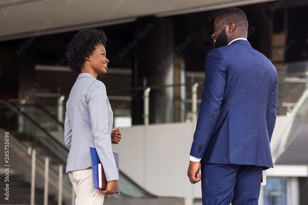 Attractive african coworkers having pleasant chat together Attractive african coworkers having pleasant chat together
