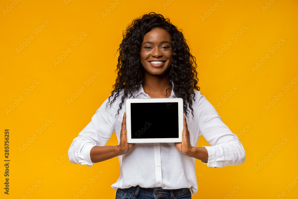 Afro smiling woman demonstrating blank digital tablet screen Afro smiling woman demonstrating blank digital tablet screen
