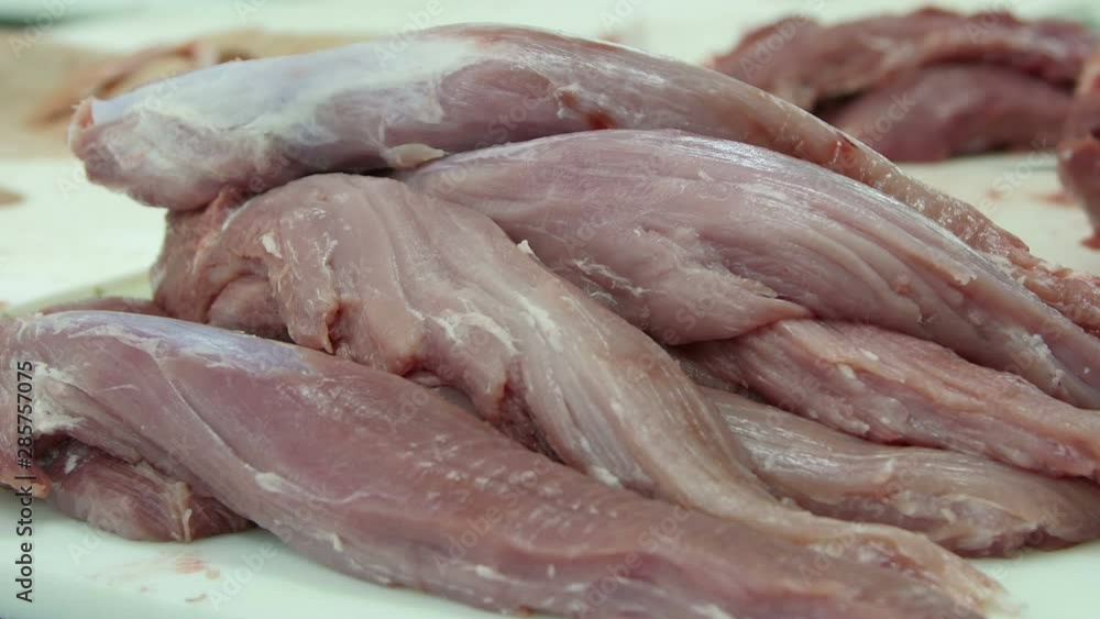 Fresh raw pork tenderloin in a meat factory Fresh raw pork tenderloin in a meat factory