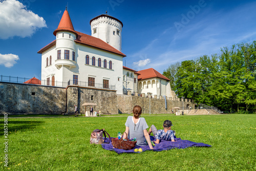 Bild auf Leinwand People in park in front of Budatin castle in Zilina, Slovakia