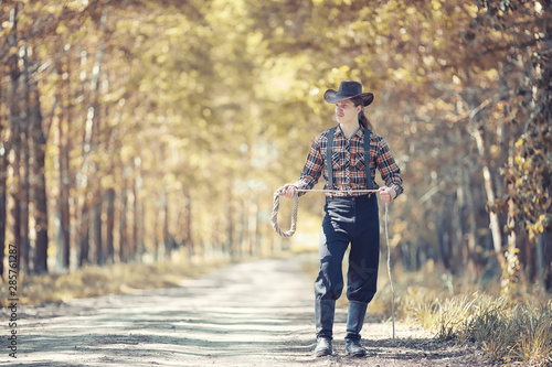 Cowboy with hat in a field in autumn