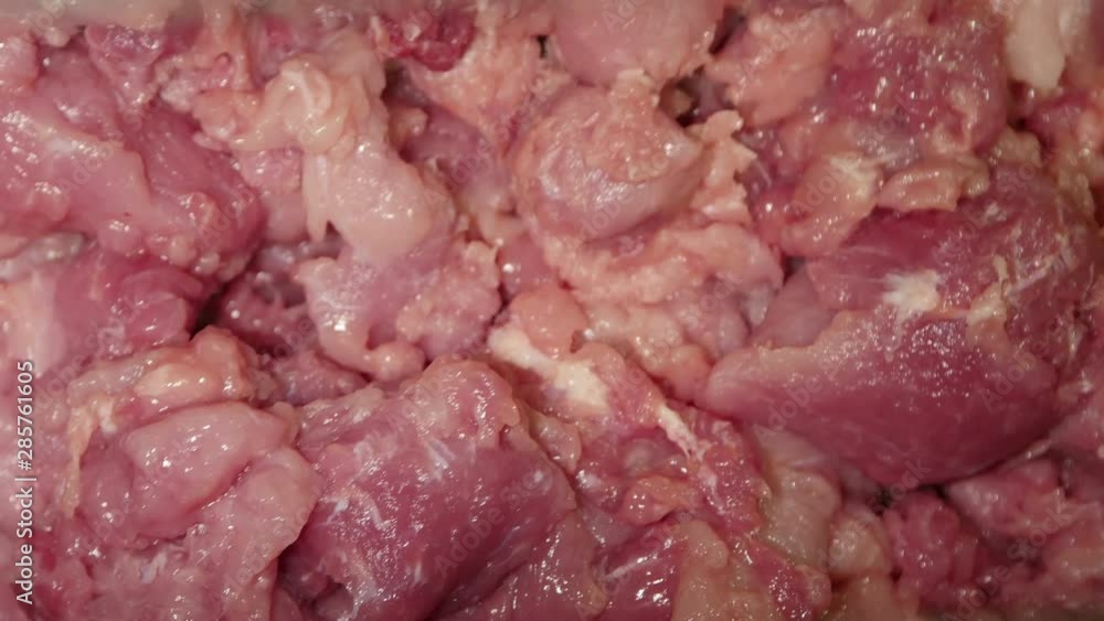 Meat mincing machine grinding meat in a meat processing factory Meat mincing machine grinding meat in a meat processing factory