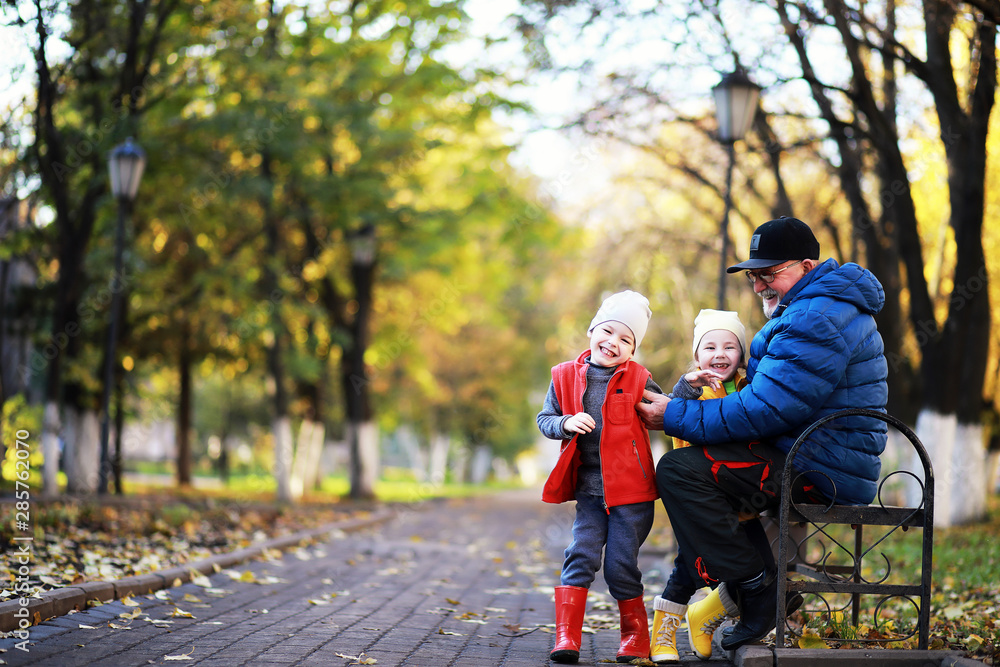 Children walk in the autumn park Children walk in the autumn park
