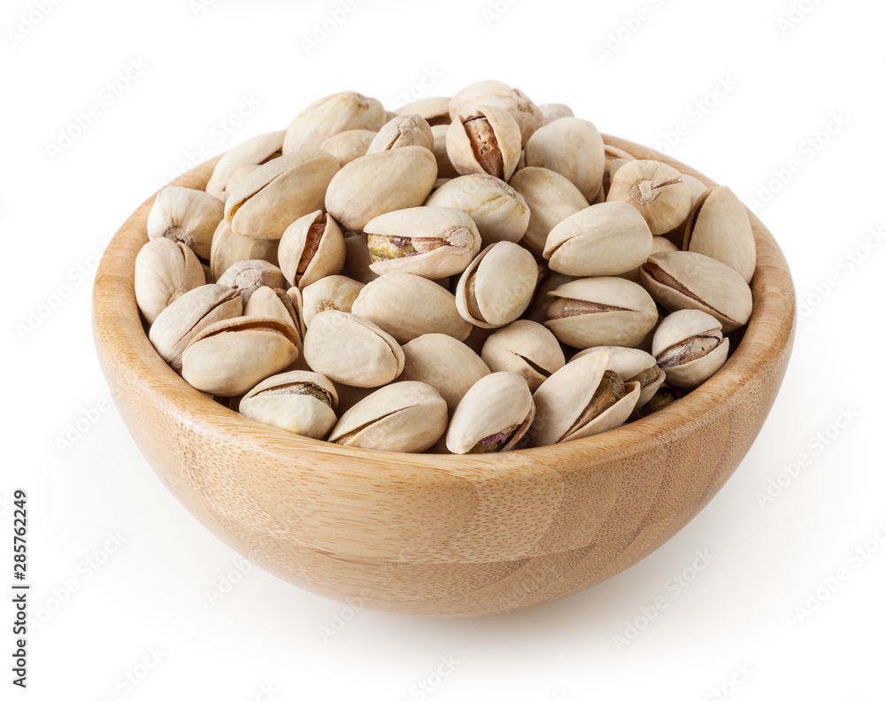Salted pistachios in wooden bowl isolated on white background with clipping path Salted pistachios in wooden bowl isolated on white background with clipping path