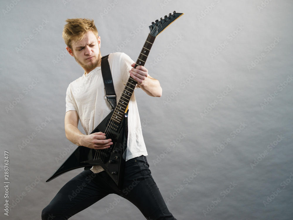 Fototapeta premium Man playing on electric guitar