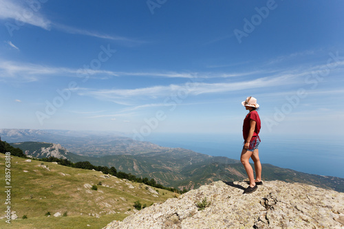 Traveller on a top of mountain, cloud sky background.