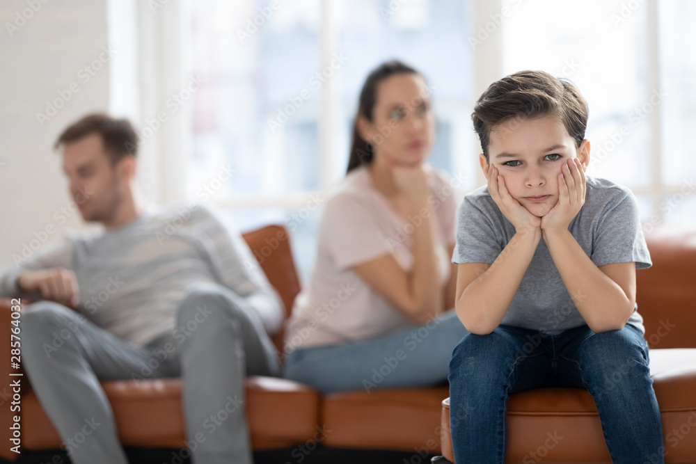 Upset child boy looking at camera sad about parents fights Upset child boy looking at camera sad about parents fights