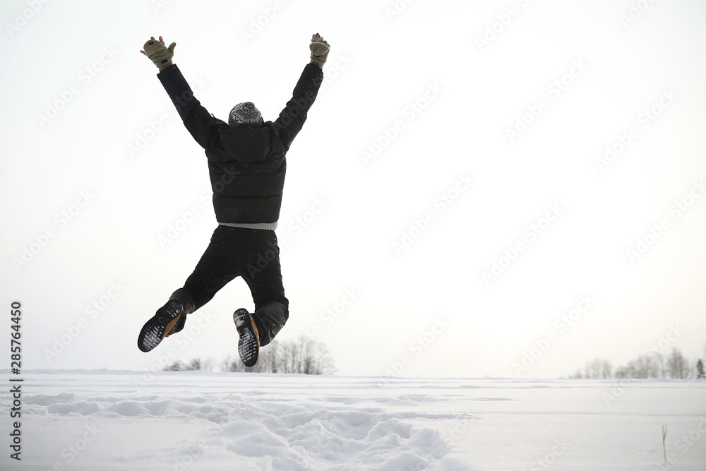 A man on a walk. Winter landscape. Tourist in winter journey.