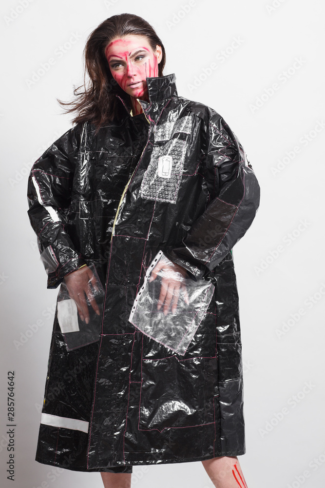 Model in a black raincoat made of 