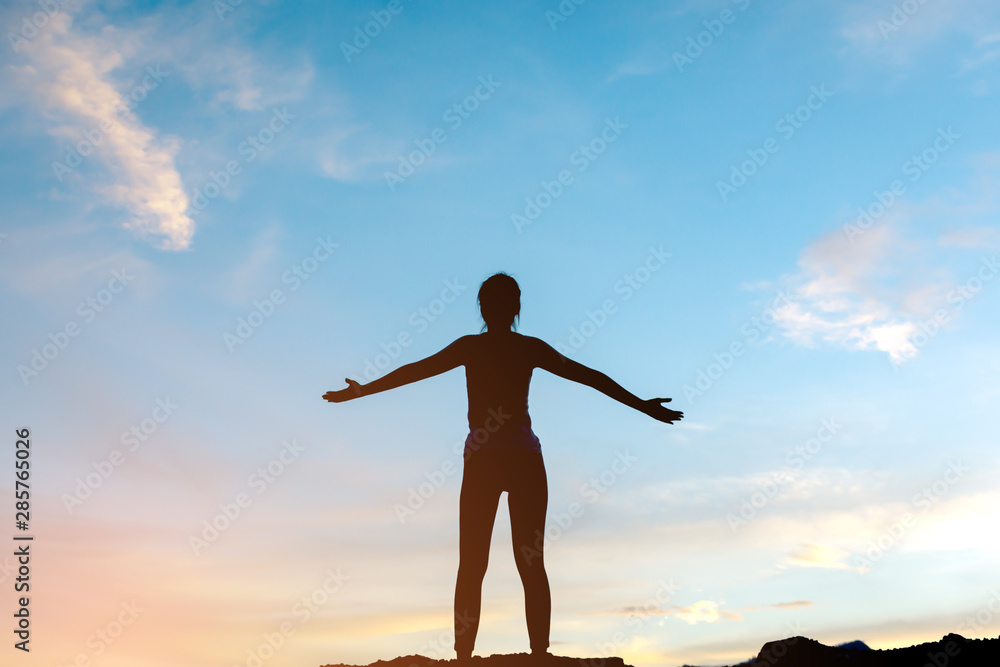 silhouette woman standing relaxing on top of mountain