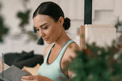 Free Download Joyful female involved in reading stock photo - GFXLoad