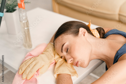 Exhausted woman sleeping during housekeeping stock photo
