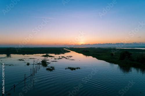 Aerial view Drone shot of Beautiful scenery sunlight in the morning sunrise above lake in phatthalung Thailand