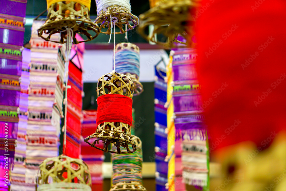 Closeup decorative wicker lantern and Lanna fabric long flags (TUNG) hang on hotel lobby ceiling and blurry background. Closeup decorative wicker lantern and Lanna fabric long flags (TUNG) hang on hotel lobby ceiling and blurry background.