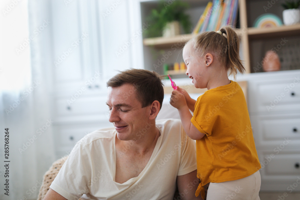 child with Down syndrome plays with dad, room child with Down syndrome plays with dad, room