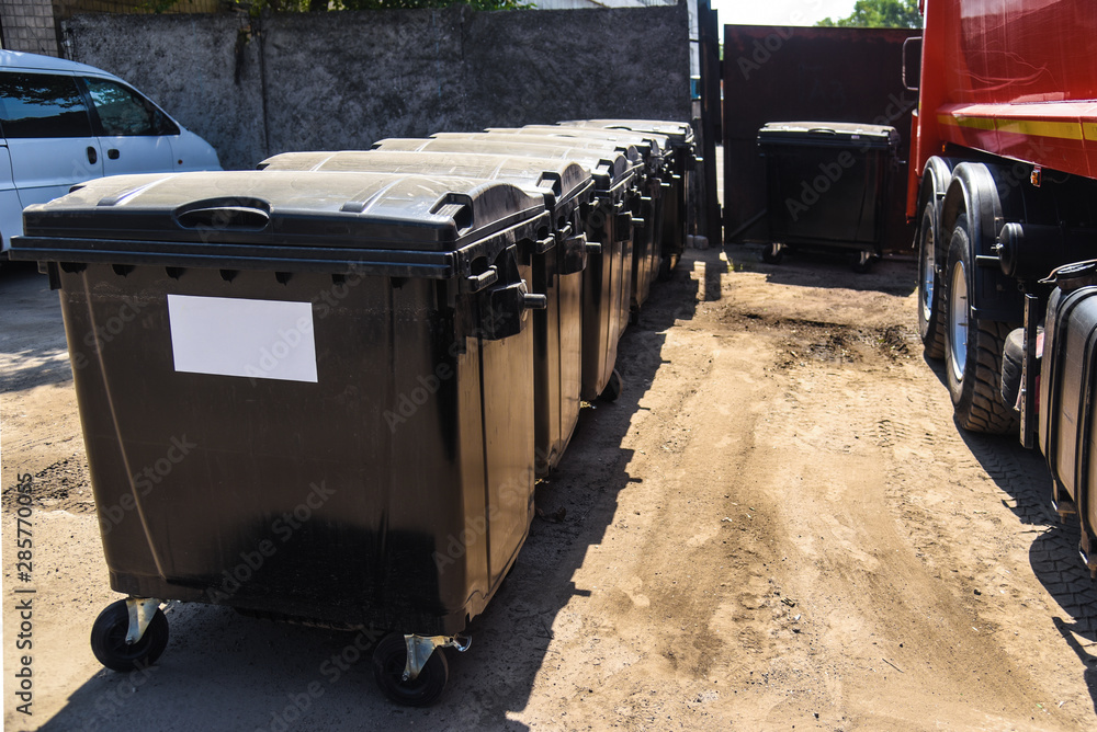 warehouse of plastic garbage containers, black warehouse of plastic garbage containers, black