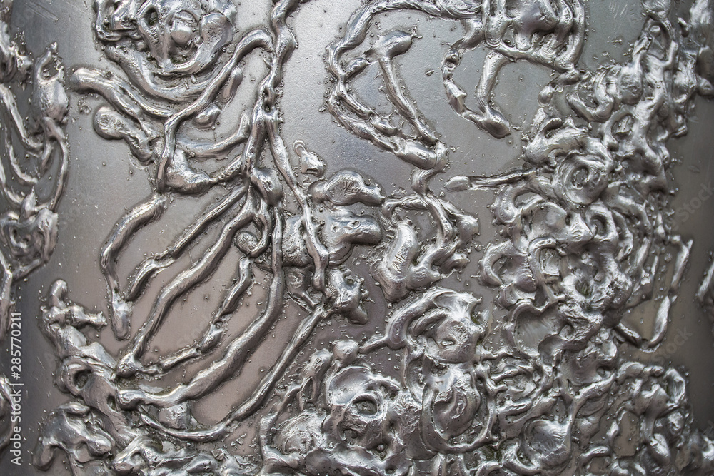 The bumpy texture of white metal. Abstract background.
