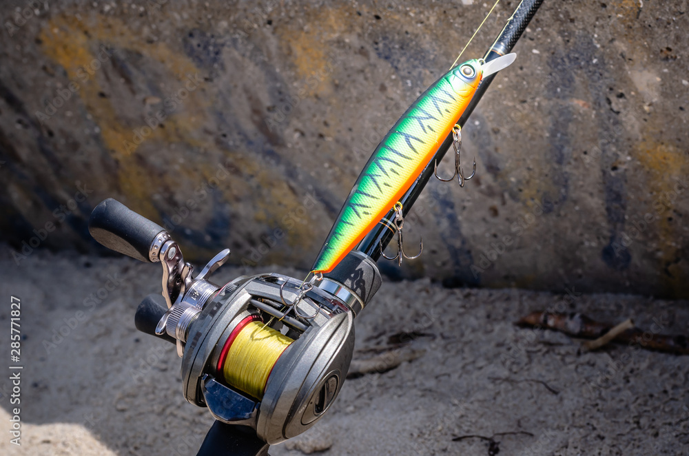 A photo of a rigged up baitcasting reel ready to catch a giant pike.  Close-up Stock Photo