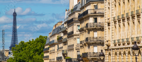 Photography Eiffel tower between Parisian tenement old street alley and buildings