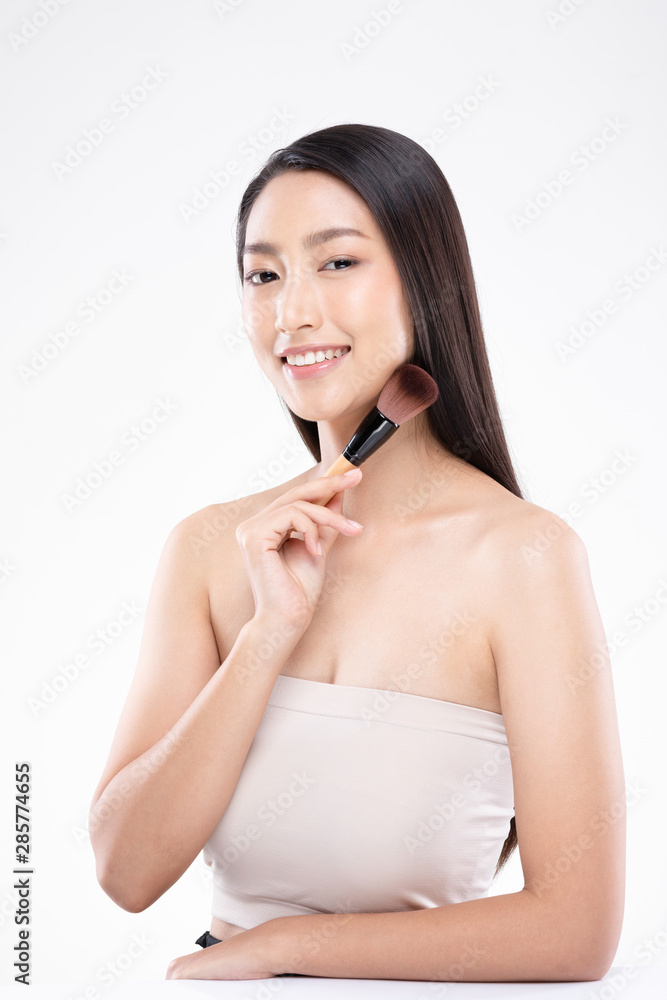 Beautiful Asian young woman smile and holding make up brush with healthy Clean and Fresh skin feeling so happiness and cheerful,Isolated on white background,Beauty Concept Beautiful Asian young woman smile and holding make up brush with healthy Clean and Fresh skin feeling so happiness and cheerful,Isolated on white background,Beauty Concept