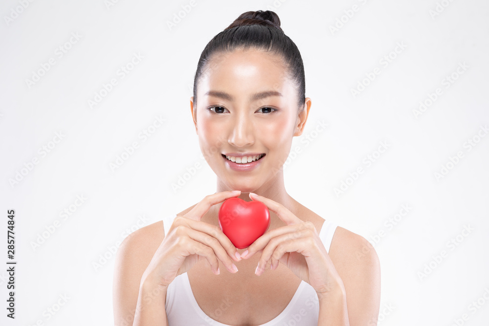 Beautiful Attractive Asian young woman smile with beautiful teeth and holding rubber heart feeling so happiness and confident,Isolated on white background,Beauty and Health care concept Beautiful Attractive Asian young woman smile with beautiful teeth and holding rubber heart feeling so happiness and confident,Isolated on white background,Beauty and Health care concept