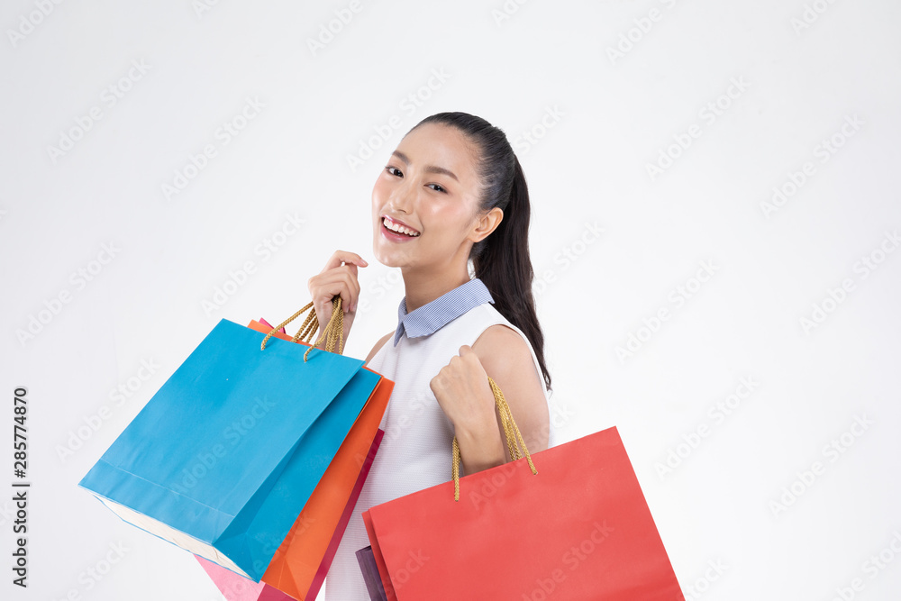Beautiful Attractive Asian Woman smile and holding shopping bags feeling so happiness and enjoy with black Friday sale in Shopping mall,isolated on white background,Shopping Concept Beautiful Attractive Asian Woman smile and holding shopping bags feeling so happiness and enjoy with black Friday sale in Shopping mall,isolated on white background,Shopping Concept