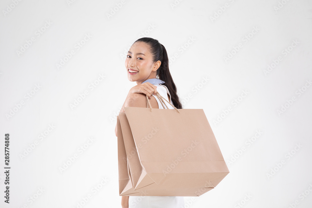 Beautiful Attractive Asian Woman smile and holding shopping bags feeling so happiness and enjoy with black Friday sale in Shopping mall,isolated on white background,Shopping Concept Beautiful Attractive Asian Woman smile and holding shopping bags feeling so happiness and enjoy with black Friday sale in Shopping mall,isolated on white background,Shopping Concept