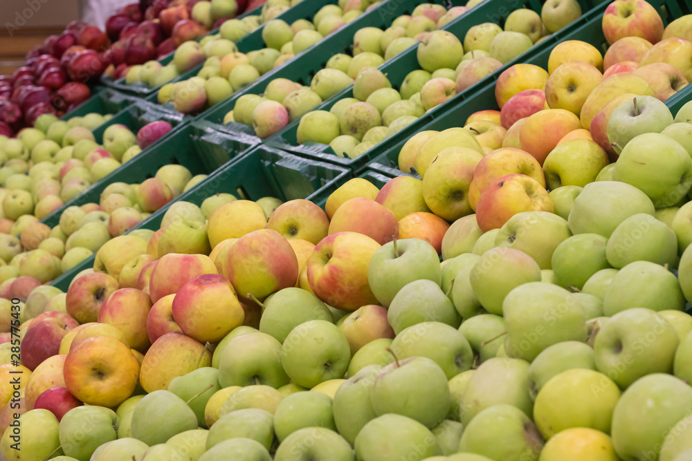 Showcase with apples in a supermarket. A lot of green apples. The choice of products. Fruit Showcase with apples in a supermarket. A lot of green apples. The choice of products. Fruit