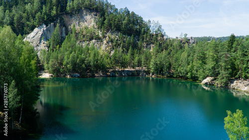 Flooded sandpit in Adrspach Rocks  lake with beautiful clear turquoise water hidden in the middle of forest  Czech Republic